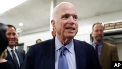 FILE - Sen. John McCain, R-Ariz., speaks to reporters as he heads to vote on budget amendments, Oct. 19, 2017, on Capitol Hill in Washington. 