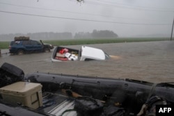 A pickup is submerged in floodwaters in Lumberton, N.C., Sept. 15, 2018, in the wake of Hurricane Florence.