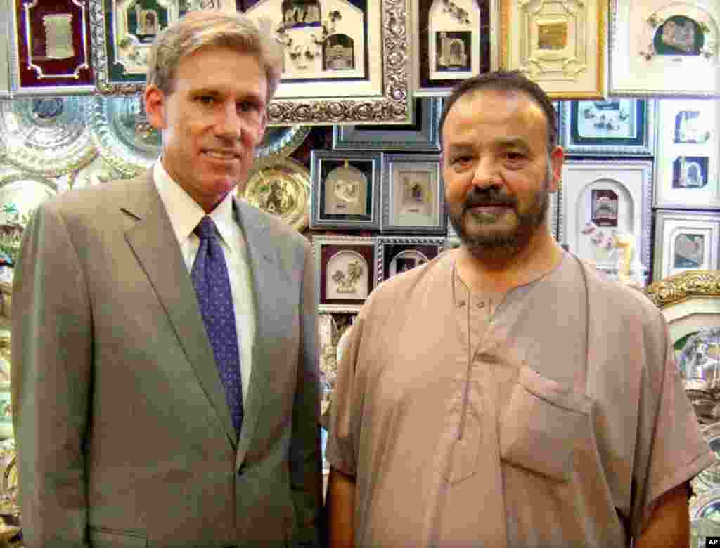 In this photo posted on the U.S. Embassy Tripoli Facebook page, Christopher Stevens poses with a shop owner in Tripoli, Libya, August 12, 2012.