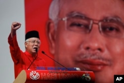 FILE - Malaysian Prime Minister Najib Razak addresses delegates during his speech at the Malaysia's ruling party United Malays National Organization's (UMNO) anniversary celebration.