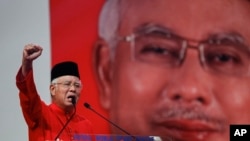FILE - Malaysian Prime Minister Najib Razak addresses delegates during his speech at the Malaysia's ruling party United Malays National Organization's (UMNO) anniversary celebration.