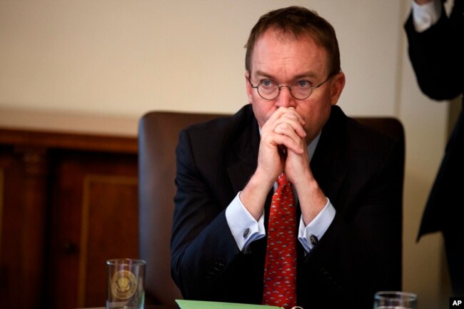 FILE - White House chief of staff Mick Mulvaney listens as President Donald Trump speaks during a Cabinet meeting at the White House in Washington.