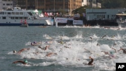 FILE - Competitors swim during the annual 1.5-kilometer (0.93-mile) harbor race at the Victoria Harbor in Hong Kong, Oct. 18, 2015.