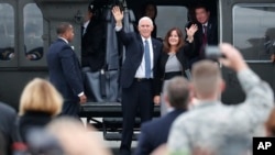 U.S. Vice President Mike Pence and his wife Karen wave before they board on the Air Force Two at Yokota U.S. Air Force Base in Fussa, on the outskirts of Tokyo Tuesday, Nov. 13, 2018.
