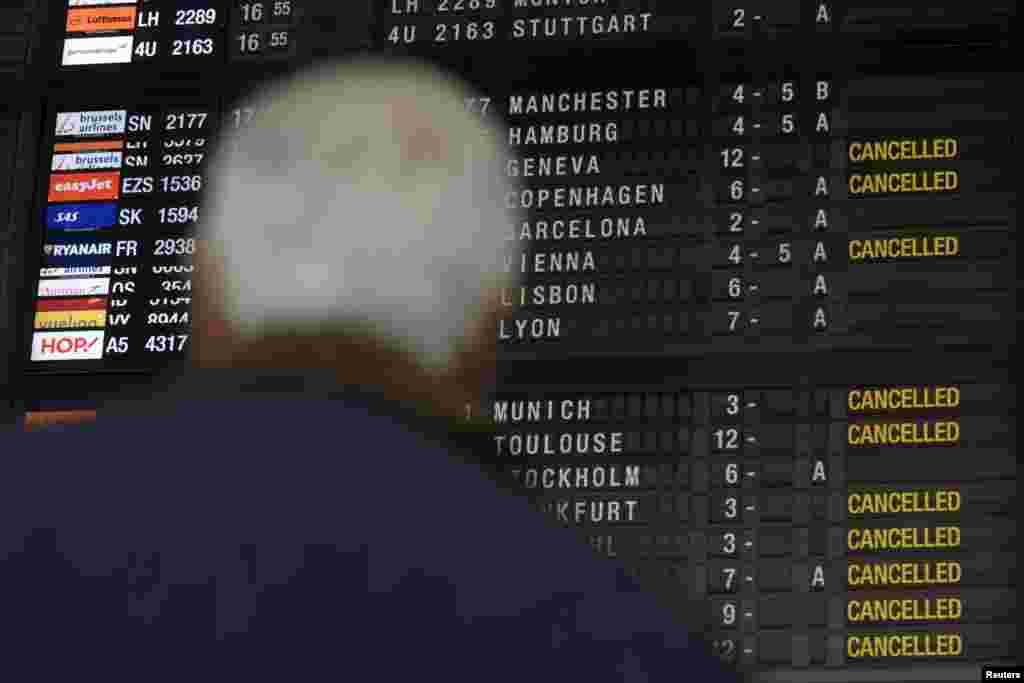 A passenger looks at the flight information screen during a regional strike at Zaventem Airport in Brussels, Belgium, Dec. 8, 2014.