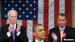 U.S. House Speaker John Boehner (R-OH) and Vice President Joe Biden (L) stand to applaud as President Barack Obama delivers his State of the Union speech on Capitol Hill in Washington, February 12, 2013. REUTERS/Charles Dharapak/Pool (UNITED STATES - Tags