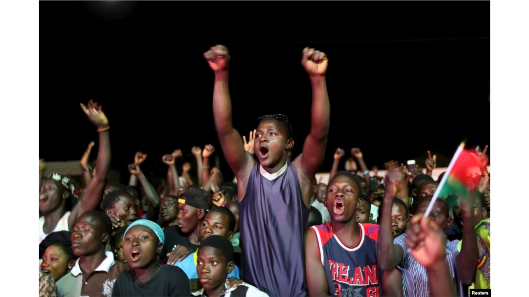 Supporters of President-elect Roch Marc Kaboré cheer at his campaign headquarters in Ouagadougou, Burkina Faso, Dec. 1, 2015.