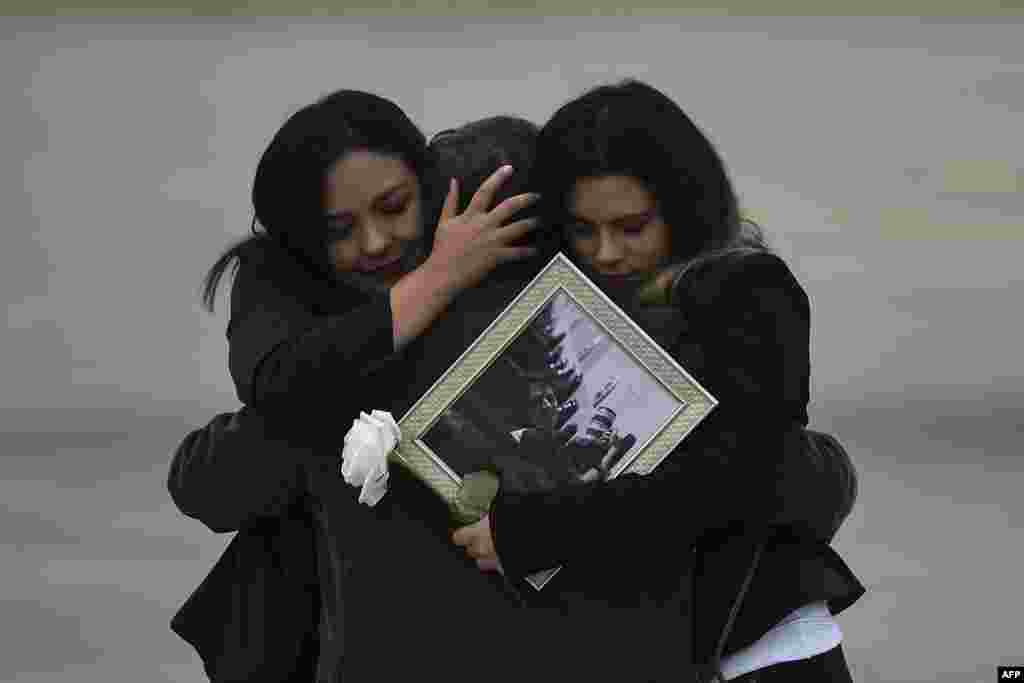 Relatives of the slain members of the news team from Ecuadorean newspaper El Comercio, embrace as the coffins containing the remains of their loved ones are carried onto an airplane of the Ecuadorean Air Force to be flown to Quito, at the Alfonso Bonilla Aragon airport in Palmira, Colombia, June 27, 2018. The trio - journalist Javier Ortega, photographer Paul Rivas and driver Efrain Segarra - had been kidnapped and slain while covering a story on violence along the remote border with Colombia prompting both countries to send troops to hunt down the perpetrators.
