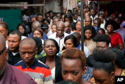 Congo opposition candidate Martin Fayulu, center, leaves the Philadelphie Missionary Center after attending Sunday Mass in Kinshasa, Congo, Jan. 13, 2019.