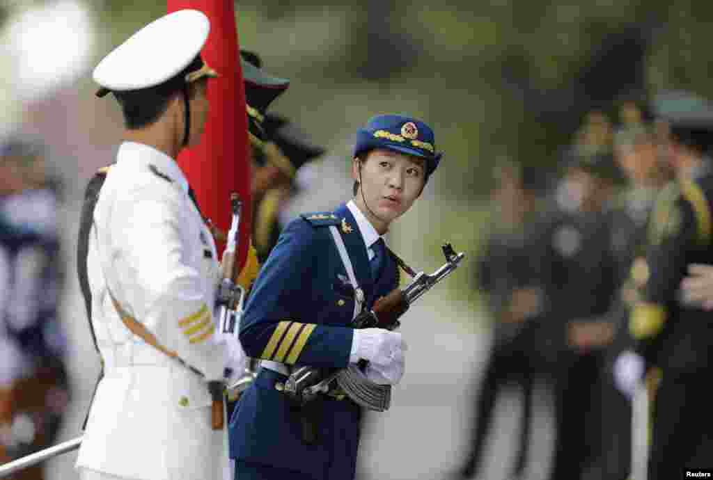 A female member of the honor guard looks on ahead of a welcoming ceremony for Malaysia&#39;s Prime Minister Najib Razak outside the Great Hall of the People, in Beijing, China.