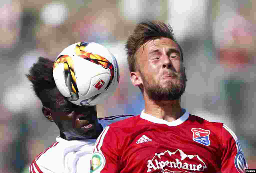 Danny Da Costa of FC Ingolstadt challenges Dominic Reisner of Unterhaching (R) during their German Cup (DFB Pokal) first round soccer match in Unterhaching, Germany.