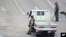 FILE: Armed soldiers patrol a street in Harare, Zimbabwe, Nov. 15, 2017. 