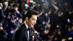 FILE - In this Friday, Nov. 21, 2014 file photo, South Korean actor Kim Woo-bin arrives for a photo call during the Daejong Film Awards in Seoul, South Korea. Chinese anger at South Korea over its decision to deploy an U.S. anti-missile defense system appears to be threatening everything from appearances by the stars of K-Pop to future cooperation on North Korea at the United Nations. 