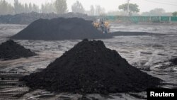 FILE - An excavator sifts through dunes of low-grade coal near a coal mine in Pingdingshan, Henan province, China November 5, 2021. (REUTERS/Aly Song)