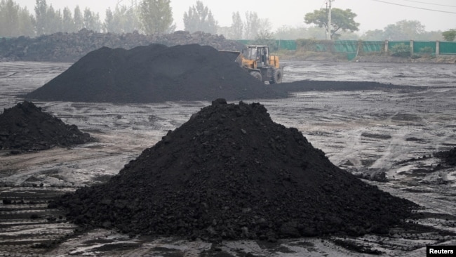 FILE - An excavator sifts through dunes of low-grade coal near a coal mine in Pingdingshan, Henan province, China November 5, 2021. (REUTERS/Aly Song)