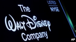 FILE PHOTO: A screen shows the logo and a ticker symbol for The Walt Disney Company on the floor of the New York Stock Exchange in New York, Dec. 14, 2017.