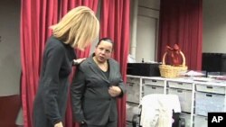 Staffer at Dress for Success helps Marty Sanabria with a dress