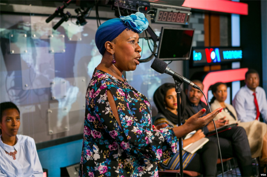 An audience member enjoys the opportunity to ask the panel the importance of their work.