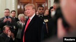 U.S. President Donald Trump arrives at a reception in the State Dining Room at the White House in Washington, March 4, 2019. 