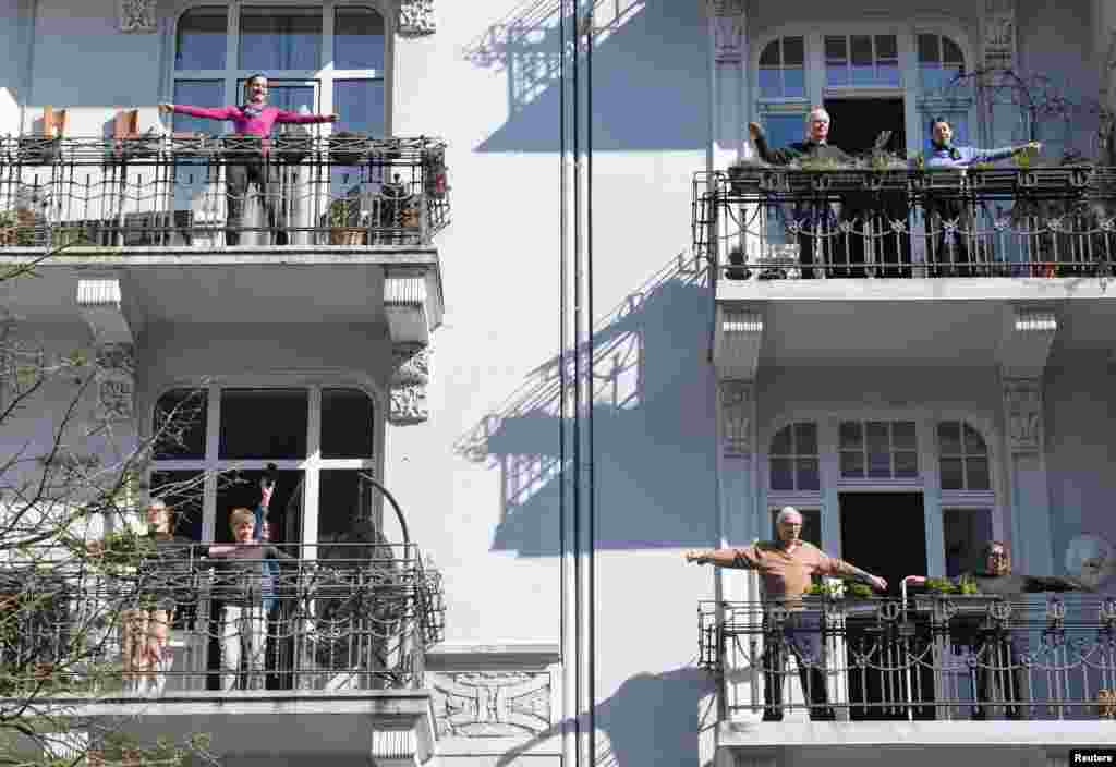 Residents exercise on their balconies in Hamburg, Germany, amid the coronavirus pandemic.