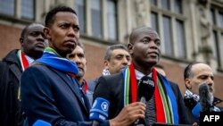 FILE - South Africa's Minister of Justice Ronald Lamola (R) delivers remarks to journalists outside the International Court of Justice (ICJ) after the first day of hearings on the genocide case against Israel brought by South Africa, in The Hague on January 11, 2024.