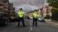 FILE - British police officers secure a cordon in a residential street in north-west London on April 28, 2017, after they carried out a specialist entry into an address as part of a Counter Terrorism investigation.