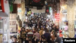 Iranians walk through Tehran Bazaar, in Tehran