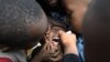 FILE - A community health worker administers a polio vaccine during a polio immunization campaign in Kiamako, Nairobi, Kenya, July 19, 2021.