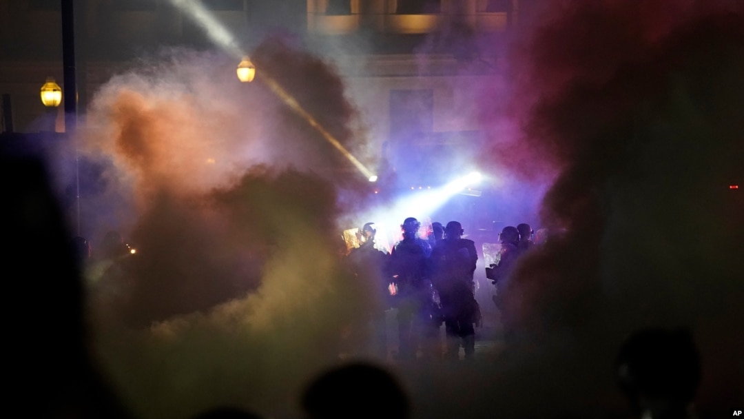 FILE - Police in riot gear respond during clashes with protesters in Kenosha, Wis., Aug. 25, 2020.