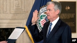 Jerome Powell takes the oath of office as the new chairman of the Federal Reserve, Feb. 5, 2018, in Washington. 