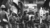 FILE - Japanese soldiers, their rifles shouldered, are seen as they march into the city and port of Ningbo, in southeastern China, May 14, 1941.