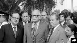 FILE - Sen. Barry Goldwater, R-Ariz., center, speaks after meeting with President Richard Nixon, Aug. 7, 1974, about resigning. With him are Senate Republican Leader Hugh Scott of Pennsylvania, left, and House GOP Leader John Rhodes of Arizona,