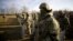 Ukrainian border guards line up at the frontier with Belarus in Ukraine's Volyn region, Nov. 11, 2021. (Ukraine Interior Ministry Press Service/Handout via Reuters)