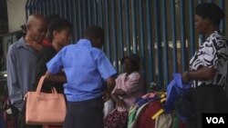 Some school children and their parents looking for school uniforms in Bulawayo streets.