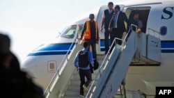 A Yemeni rebel delegation prepares to fly on a Kuwaiti plane accompanied by a U.N. peace envoy, heading for talks in Sweden with the government aimed at ending the country's devastating war, Dec. 4, 2018, in Sanaa.