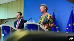 Greek Minister for Migration and Asylum Notis Mitarachi, left, and EU commissioner for Home Affairs Ylva Johansson participate in a media conference at EU headquarters in Brussels, June 9, 2021. 