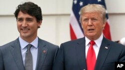 President Donald Trump and Canadian Prime Minister Justin Trudeau pose for a photo as Trudeau arrives at the White House in Washington, Wednesday, Oct. 11, 2017. 