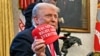 President Donald Trump holds a hat reading "Trump was right about everything" after signing an order on the supply of copper and foreign copper in the American market at the Oval Office of the White House in Washington on Feb. 25, 2025.