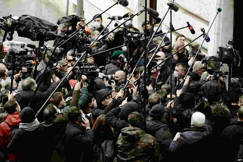 Journalists gather upon the arrival of leader of the right-wing party Forza Italia, Silvio Berlusconi (not in picture) at Palazzo Montecitorio, the seat of the lower house of parliament in Rome, Italy, for a meeting with ex-central banker Mario Draghi.