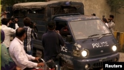 Pakistani police drive men accused of child abuse to the Lahore High Court in Pakistan, August 11, 2015.