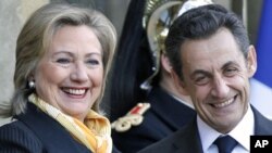 U.S. Secretary of State Hillary Clinton (L) is greeted by France's President Nicolas Sarkozy upon her arrival at the Elysee Palace in Paris, March 14, 2011