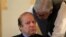 FILE - Former Pakistani Prime Minister Nawaz Sharif speaks with an official during a meeting in Islamabad, Aug. 9, 2017. 