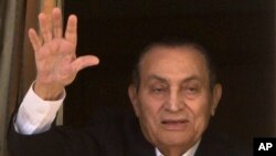 Ousted former Egyptian President Hosni Mubarak waves to his supporters from his room at the Maadi Military Hospital, where he is hospitalized, as they celebrate Sinai Liberation Day that marks the final withdrawal of all Israeli military forces from…