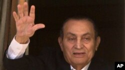 Ousted former Egyptian President Hosni Mubarak waves to his supporters from his room at the Maadi Military Hospital, where he is hospitalized, as they celebrate Sinai Liberation Day that marks the final withdrawal of all Israeli military forces from…