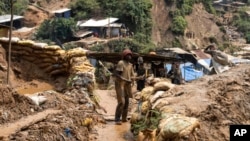 FILE - Miners locomotion  Sept. 5, 2024, successful  Kamituga, eastbound   Congo.