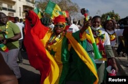 FILE—Supporters of Senegal's president Macky Sall march in support of him after the postponement of the February 25 presidential election and ahead of a national dialogue proposed by Sall, in Dakar, Senegal, February 24, 2024.