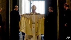 FILE - Pope Francis opens the Holy Door of St. Peter's Basilica at the Vatican, Dec. 8, 2015. 