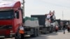 Workers from the Palestinian Red Crescent unload lorries carrying humanitarian aid after they entered the Gaza Strip from Egypt via the Rafah border crossing on October 21, 2023.
