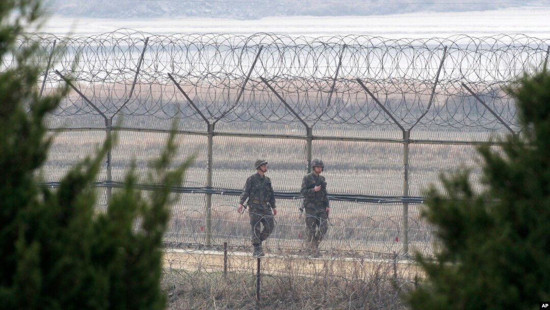 South Korean army soldiers patrol along a barbed-wire fence in Paju, near the border with North Korea, South Korea, March 27, 2014. 