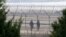 South Korean army soldiers patrol along a barbed-wire fence in Paju, near the border with North Korea, South Korea, March 27, 2014. 
